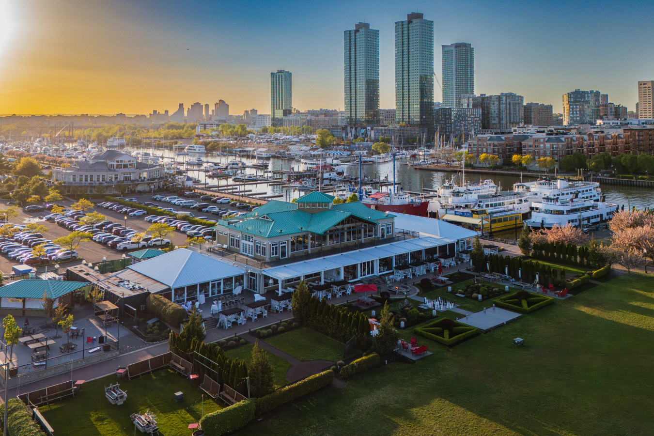The Liberty Landing waterfront restaurant and marina complex at golden hour, steps from FLOHOM 16 | Isaac's Way
