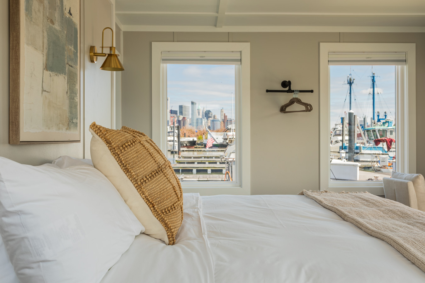 Wake up to the Manhattan skyline from your pillow, with sailboats and open water filling the view just beyond the glass.