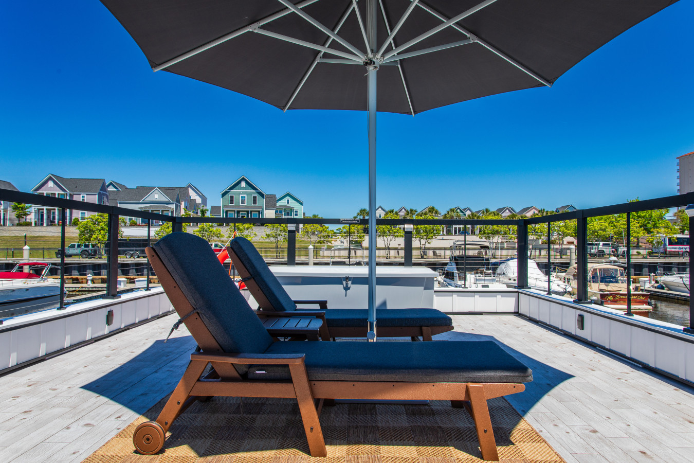 The rooftop chaise lounges and shade umbrella under a clear Carolina sky.