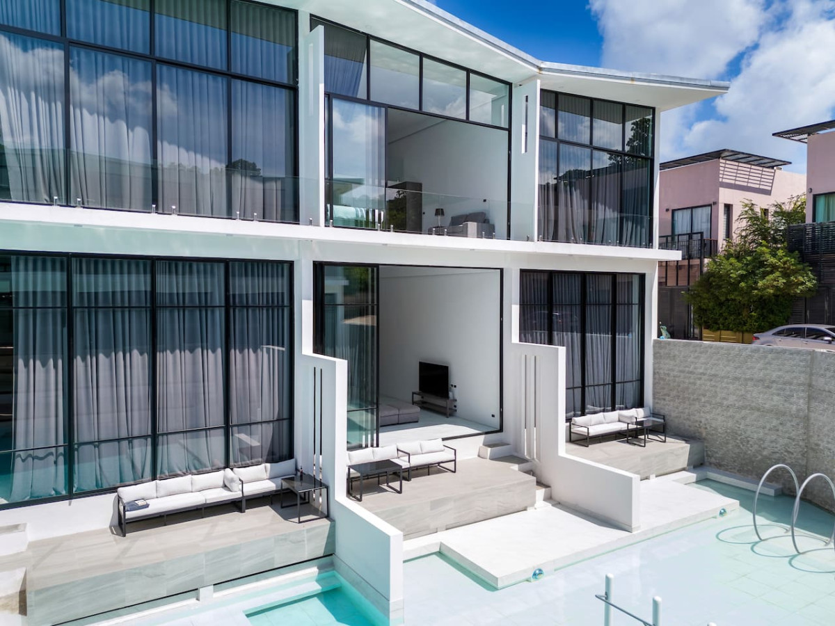 Spacious outdoor balcony with lounge seating and pool view at this Samui holiday villa