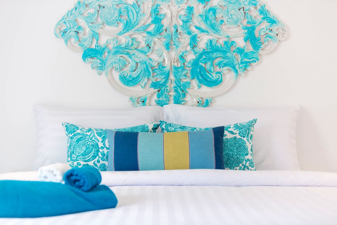 Coastal-themed bedroom with turquoise decor Thongsong Bay villa