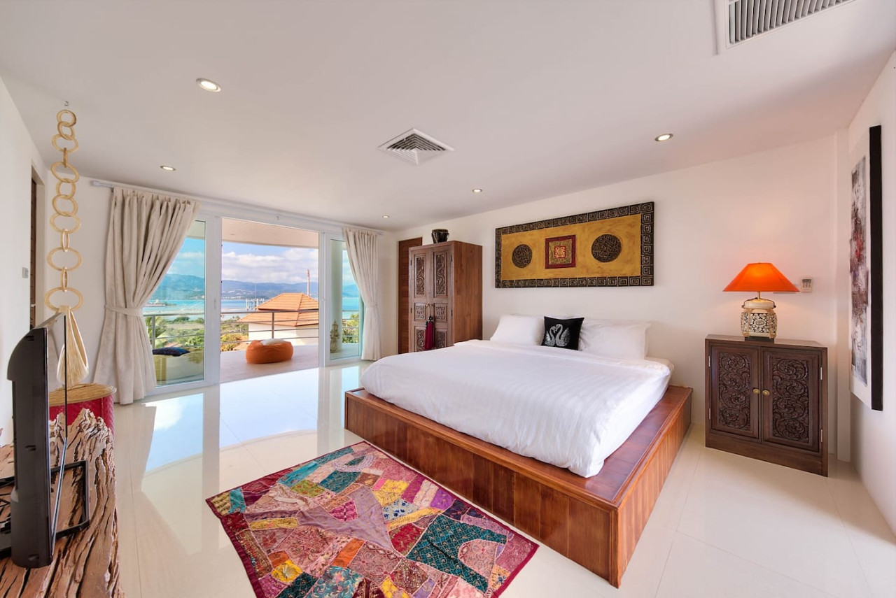 Master bedroom with colorful Thai textiles and ocean views Koh Samui
