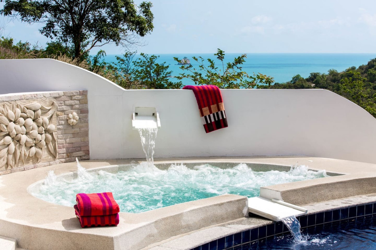 Pool waterfall feature with turquoise accents Thongsong Bay villa