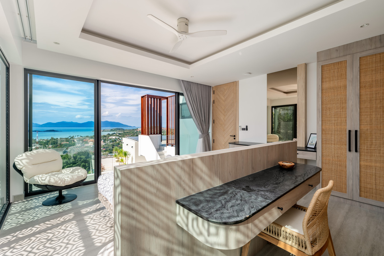 Light-filled living area with soaring ceiling and ocean panorama