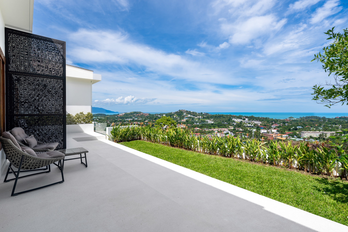 Modern wooden terrace deck with open sky and garden views