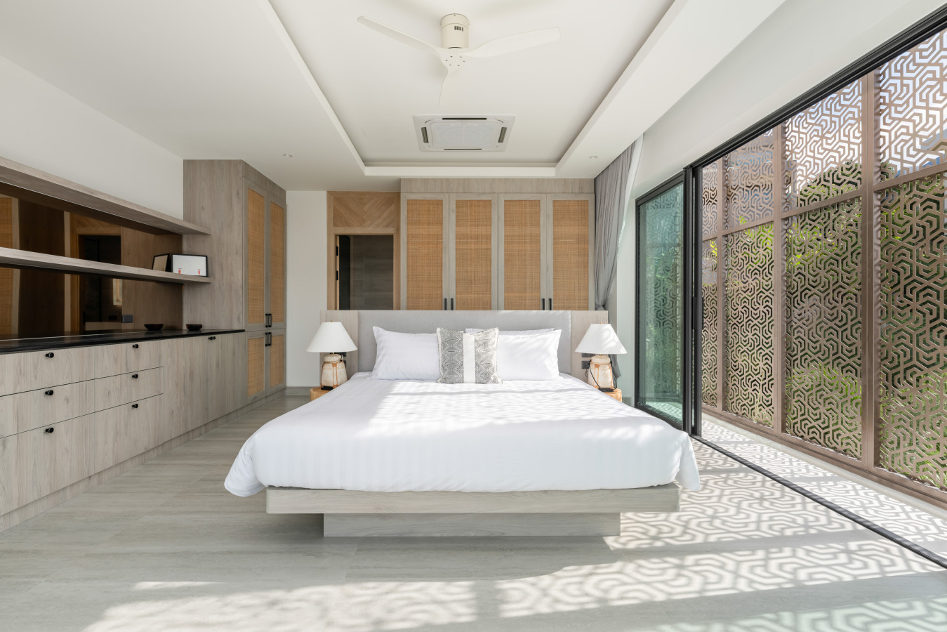 Spacious master bedroom with elegant textured accent wall