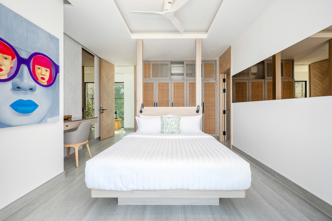 Bright bedroom with artistic decor and garden views