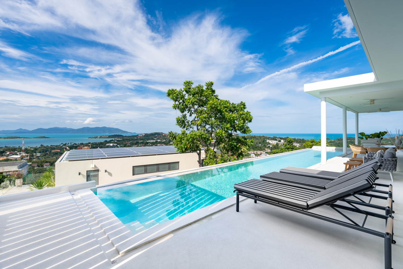 Poolside sun loungers with stunning ocean and island panorama