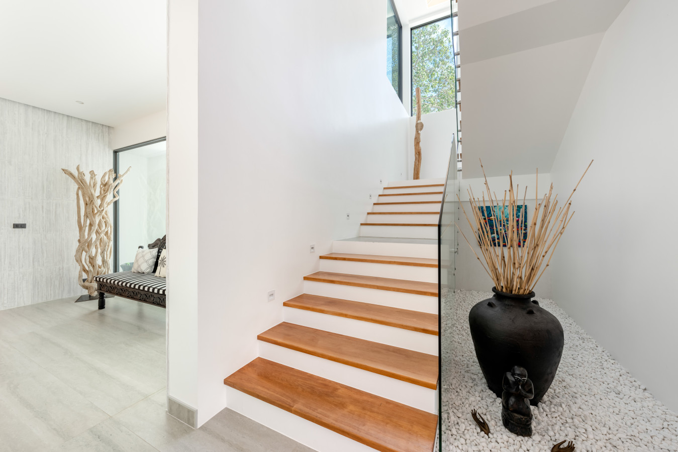 Elegant wooden staircase connecting the villa levels