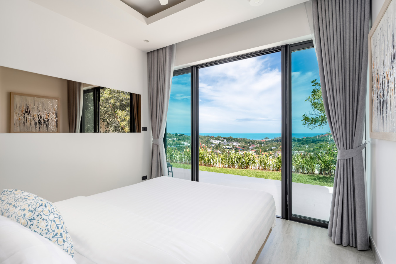 Bright and airy bedroom with king bed and tropical garden views