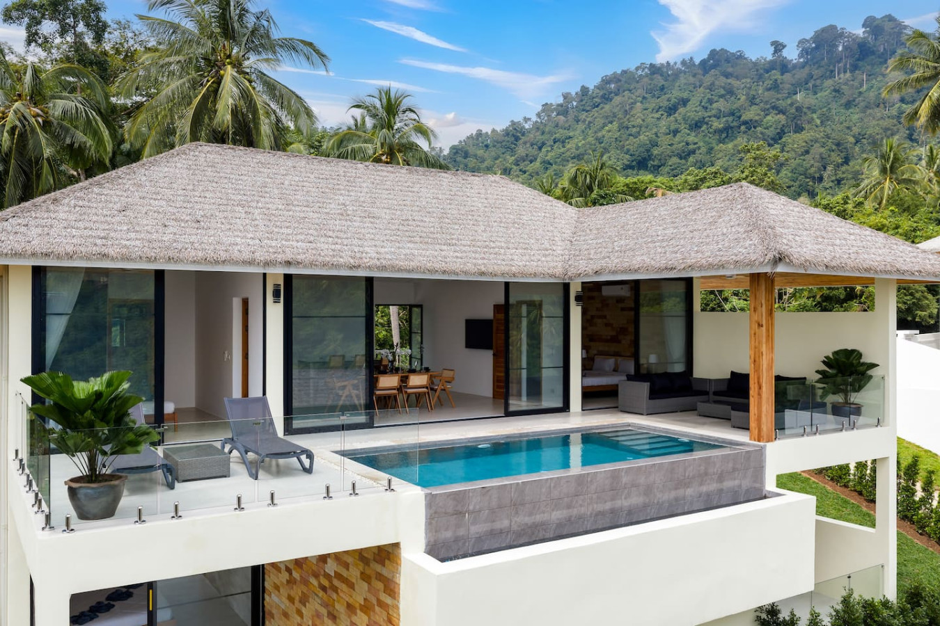 Aerial view of private pool and thatched pavilion surrounded by tropical gardens, Koh Samui