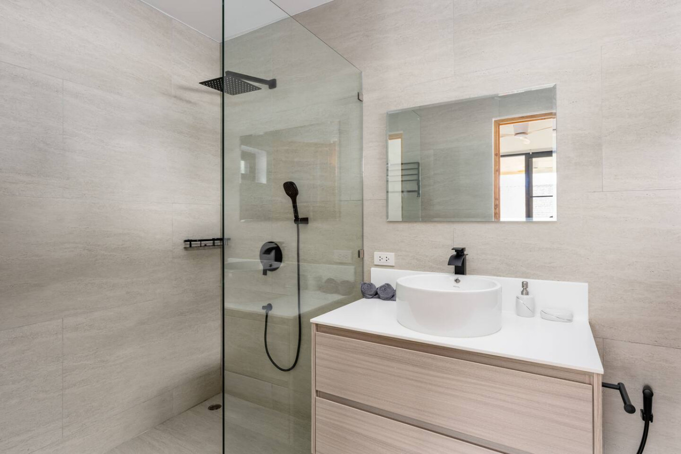 Elegant white bathroom with freestanding bathtub and glass shower at Koh Samui luxury villa