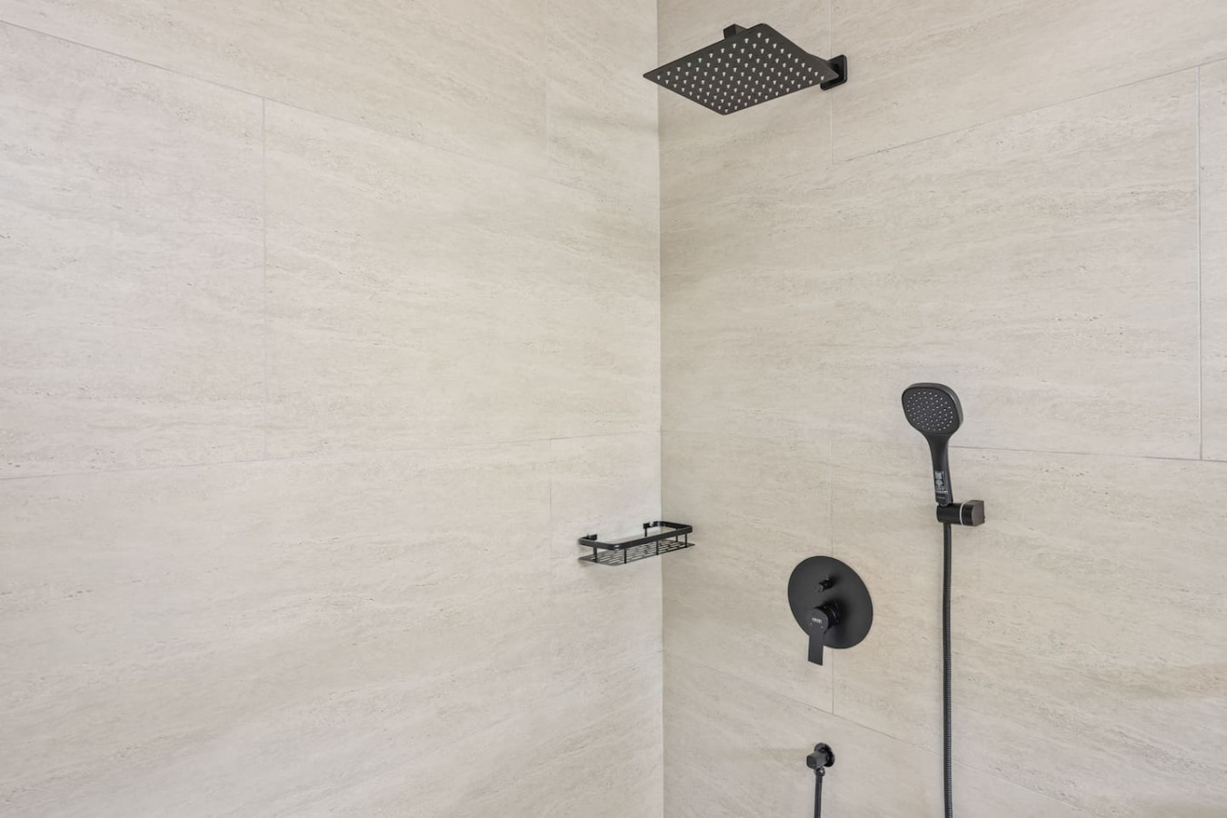 Designer rain shower with matte black fixtures in modern Koh Samui villa bathroom