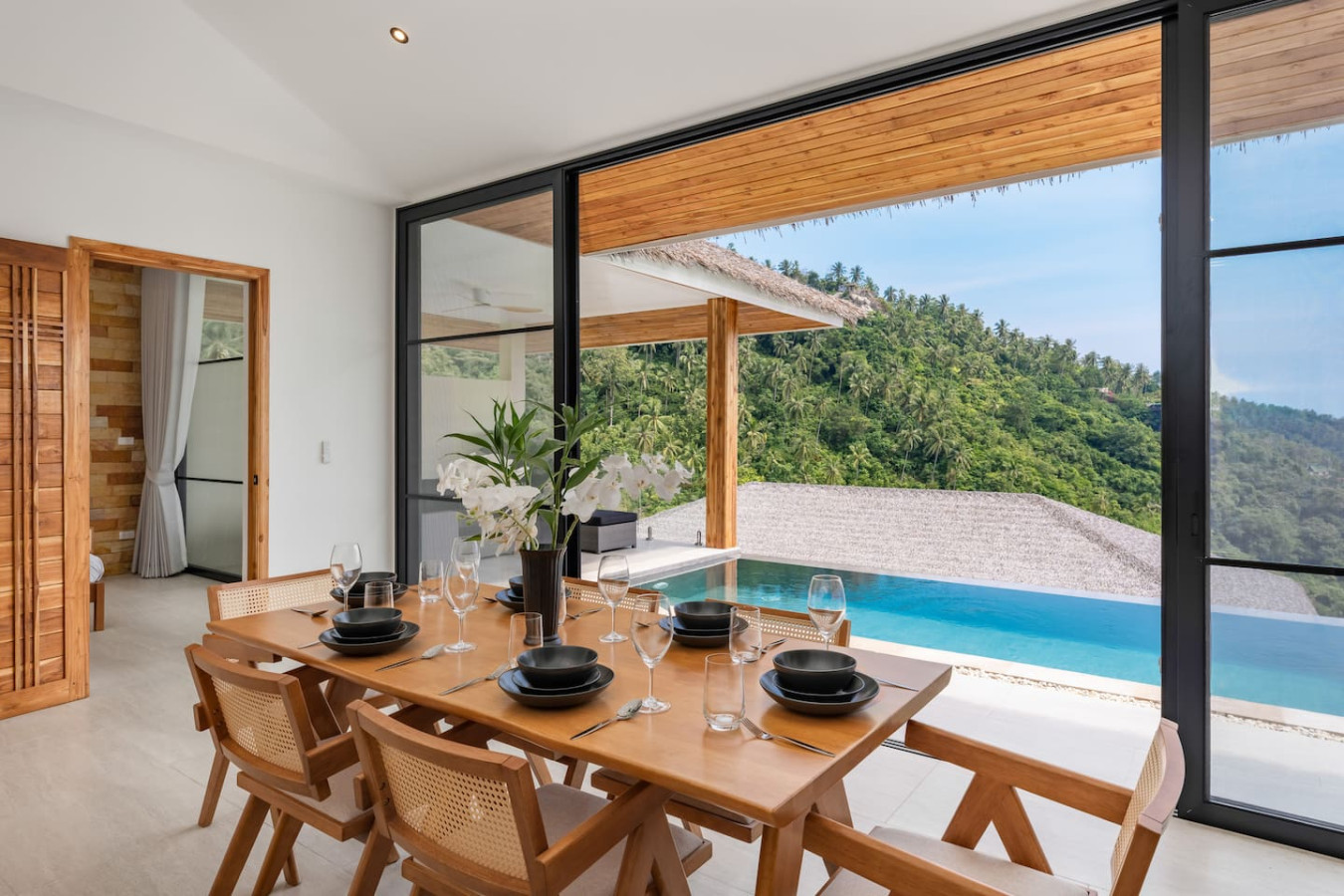 Sparkling pool with sun loungers and thatched-roof sala at Sunrise Hill Villa Koh Samui Thailand
