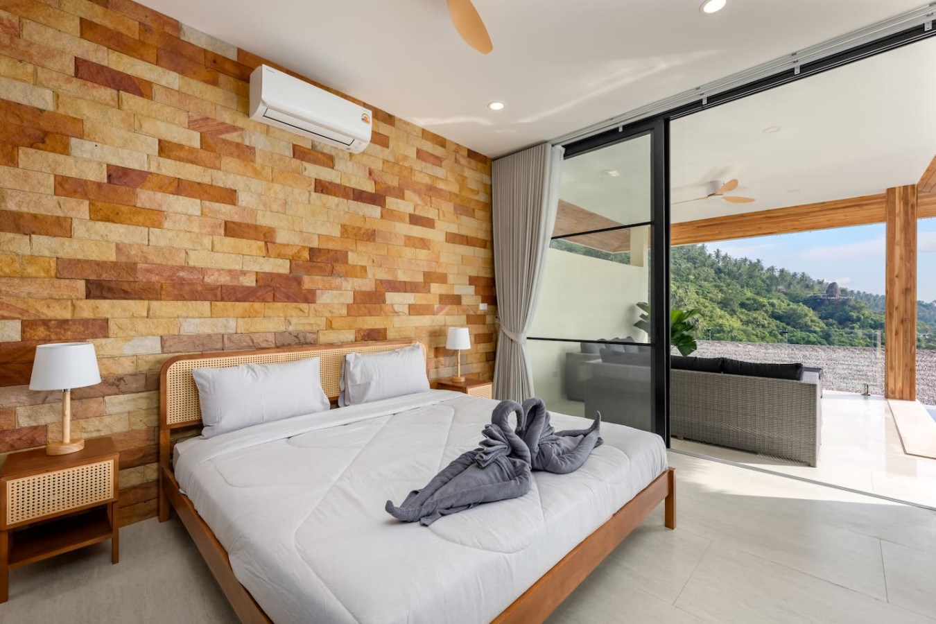 Spacious master bedroom with dark wood accents and garden outlook at Koh Samui private villa