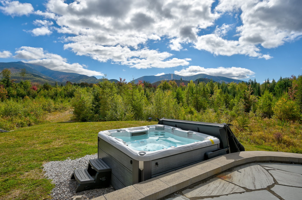 Indulge in our 6 person hot tub with views of Cannon Mountain