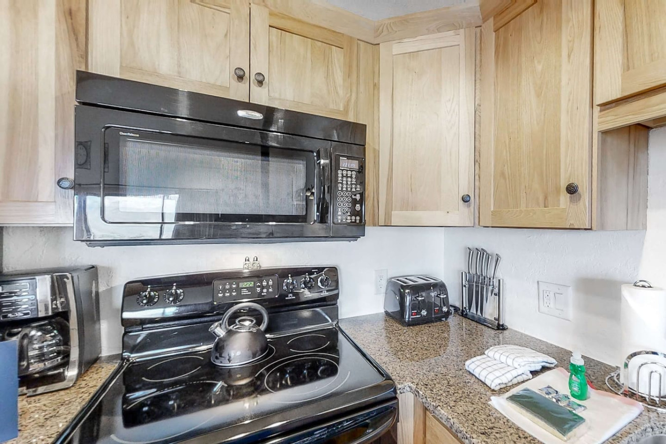 Fully stocked kitchen with beautiful wood cabinets, modern appliances, and all essentials for a great meal. Coffee and tea are provided for your stay!