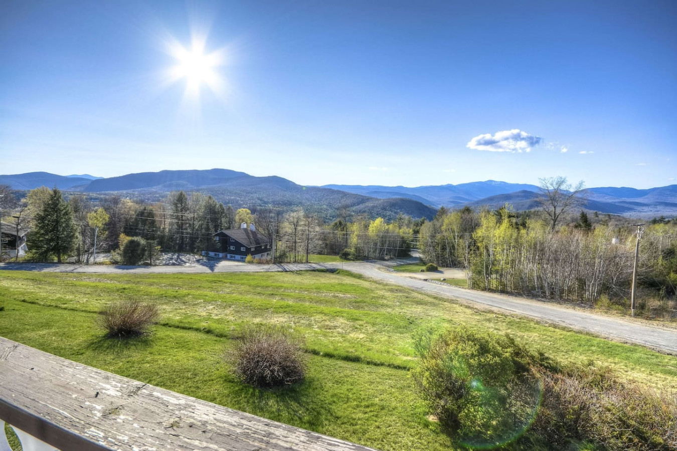 Breathtaking balcony view of rolling mountains, lush greenery, and endless blue skies—perfect for relaxing and soaking in nature’s beauty.