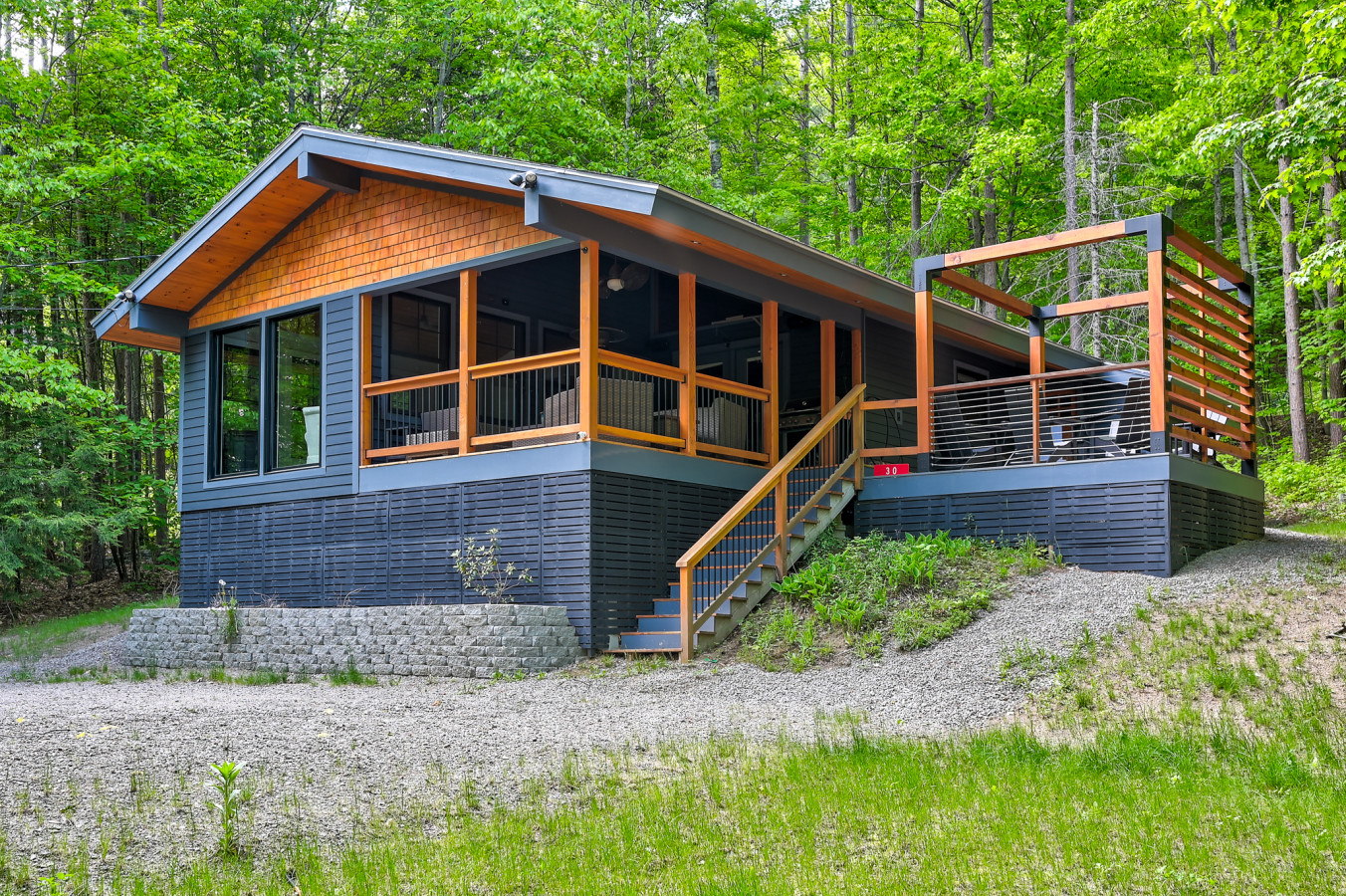 Modern chalet with private hot tub, forest views, and cozy indoor-outdoor living.