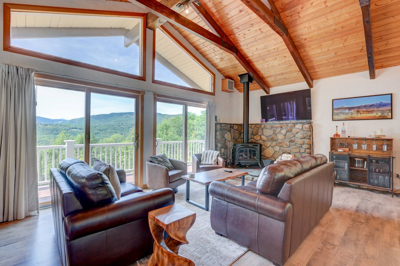 Our cozy den features an open floor plan with a gas fireplace, stunning views, a large TV, and a welcoming bar area — the perfect place to unwind.