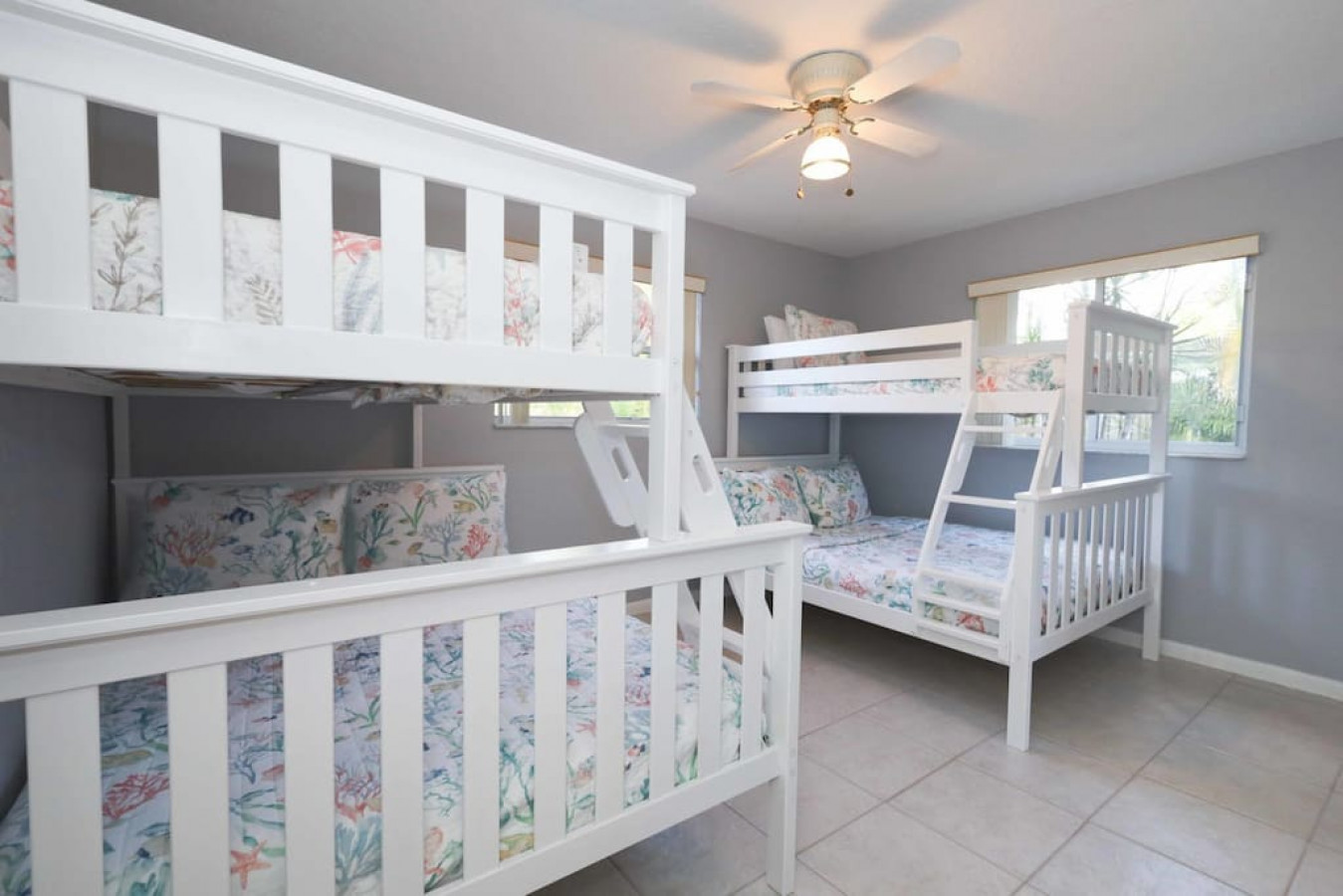 With two twin over full bunk beds, this room fits kids, teens, or adults easily