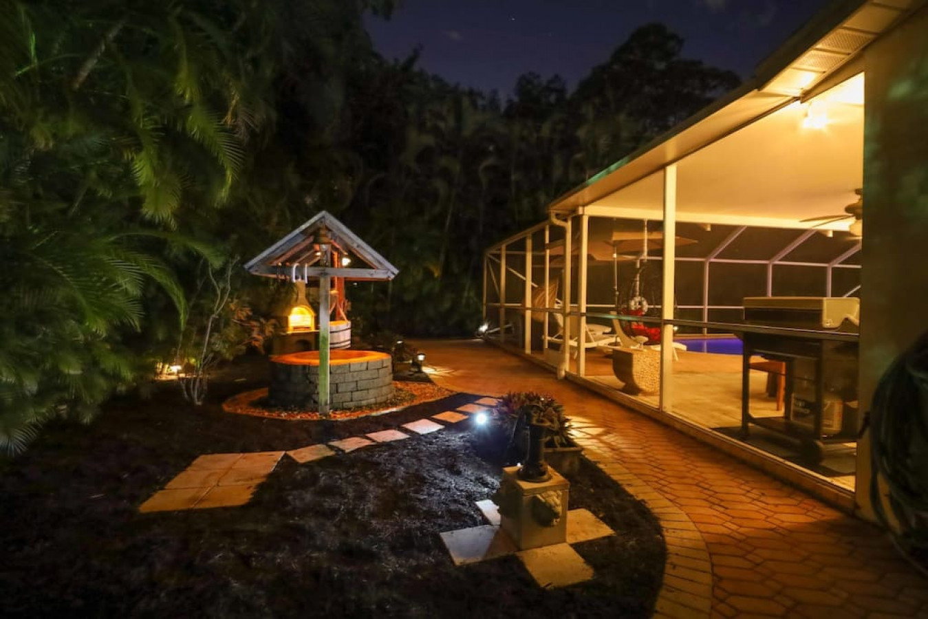 Get lost in the view of the backyard aglow with custom accent lighting as you swim in the pool or dine al fresco