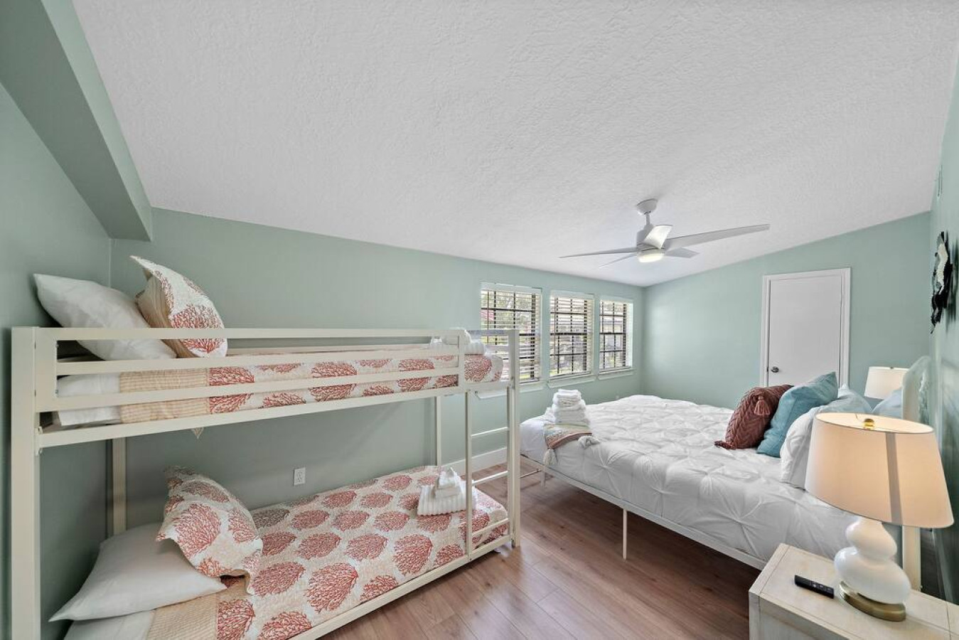 This bedroom has a king sized bed and a twin bunk bed