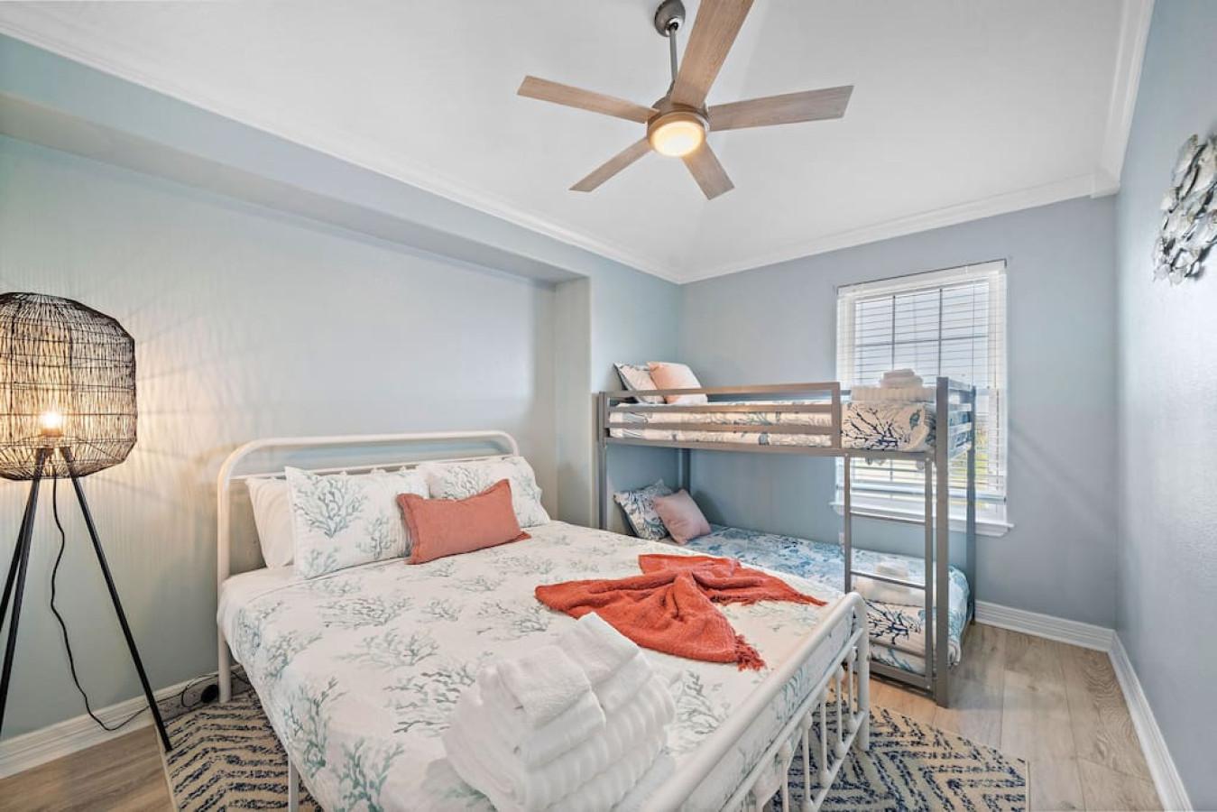 Cozy repose meets design brilliance in this stylish bedroom with this queen bed and full-sized bunk beds