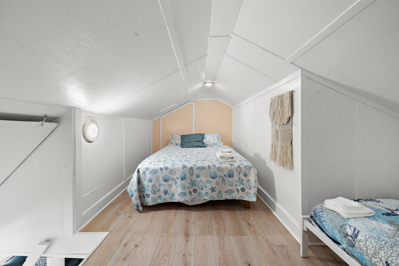This bedroom has a queen sized bed and a twin bed
