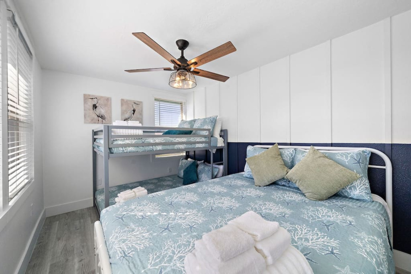 This bedroom has a queen bed and a twin bunk bed
