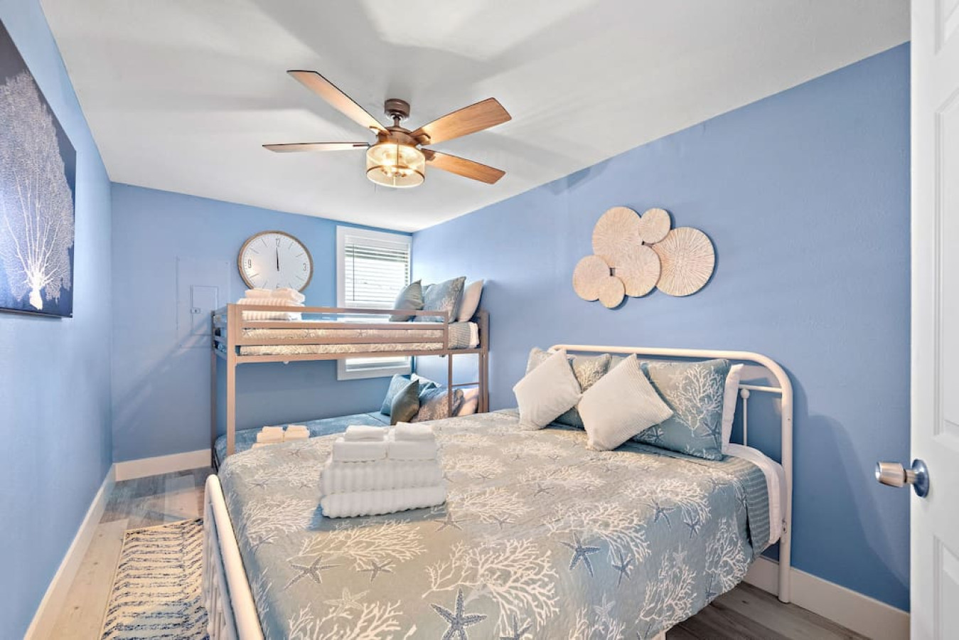 This bedroom has a queen bed and a twin bunk bed