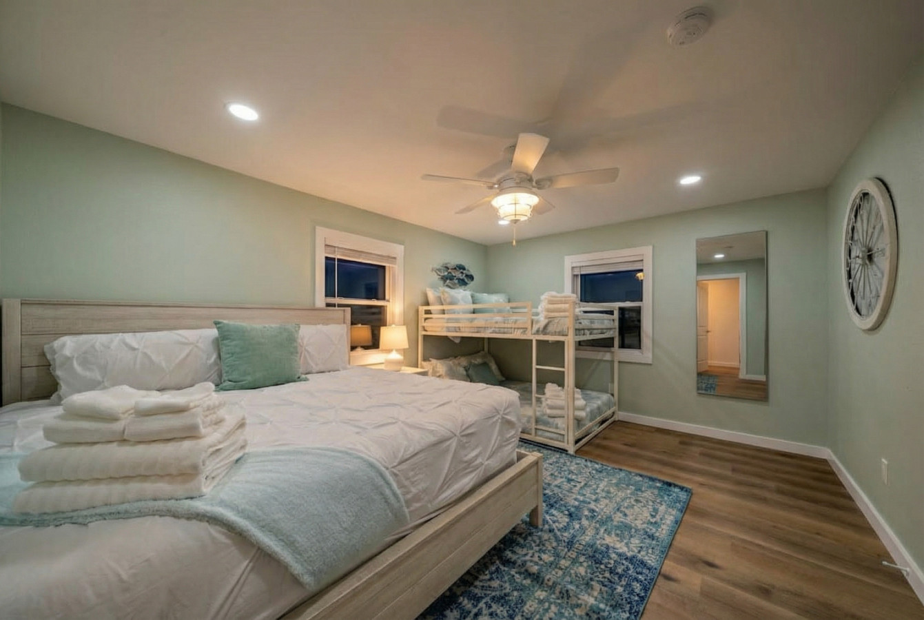 This bedroom has a king sized bed and a double bunk bed