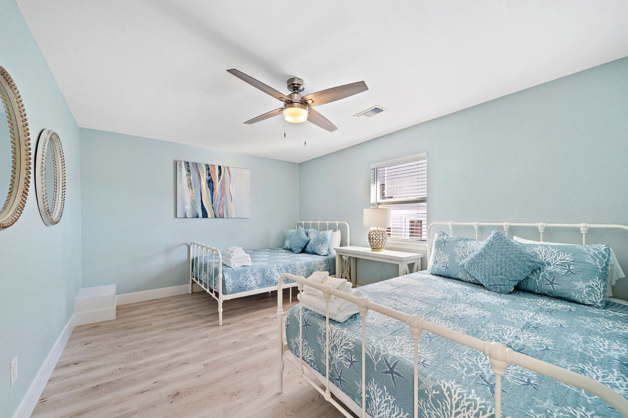 This bedroom has 2 queen sized beds