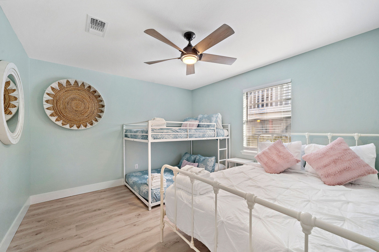 This bedroom has a queen bed and a full-sized bunk bed