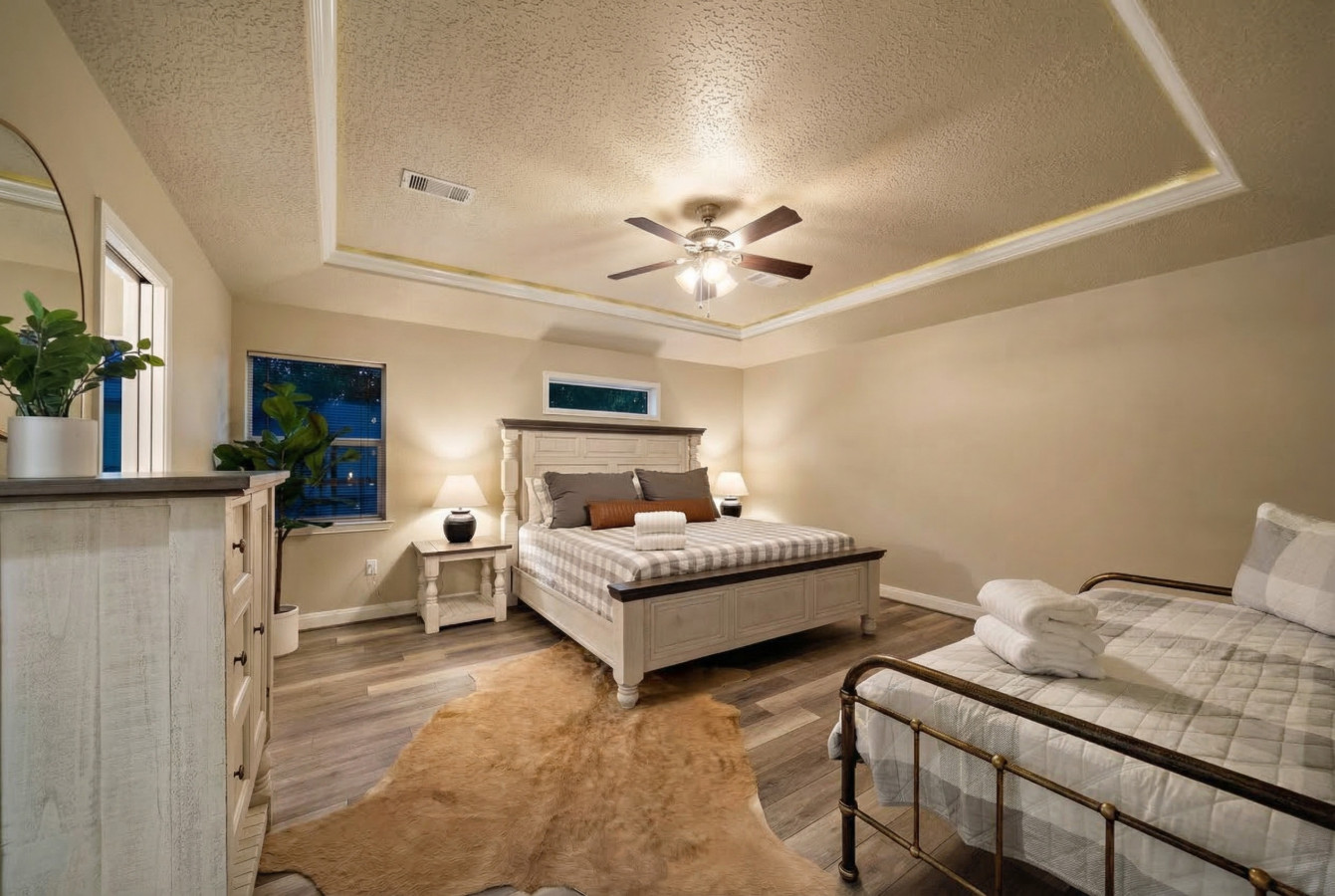 This bedroom has a king bed and a day bed