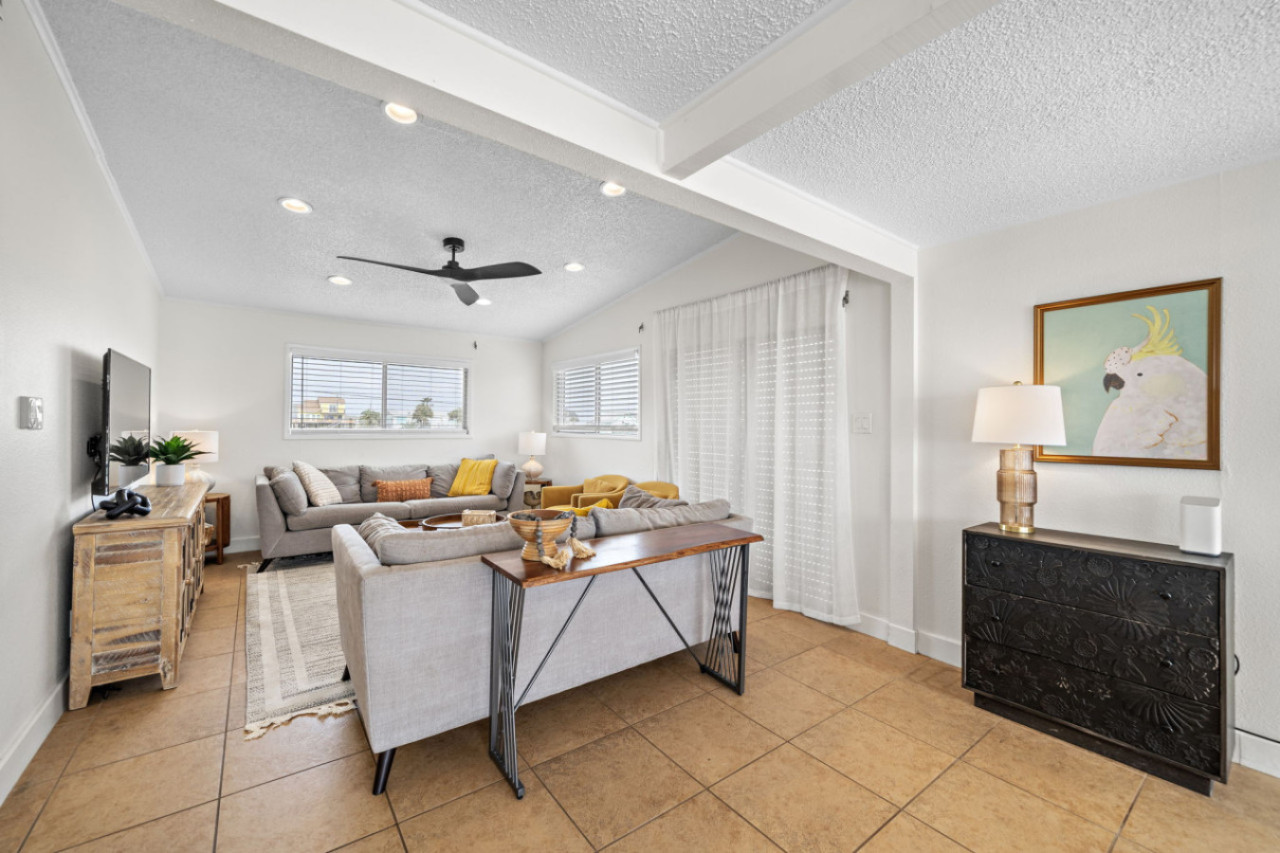 Settle in, pop the popcorn, and watch your favorites on the flat screen smart TV in this beautiful living room