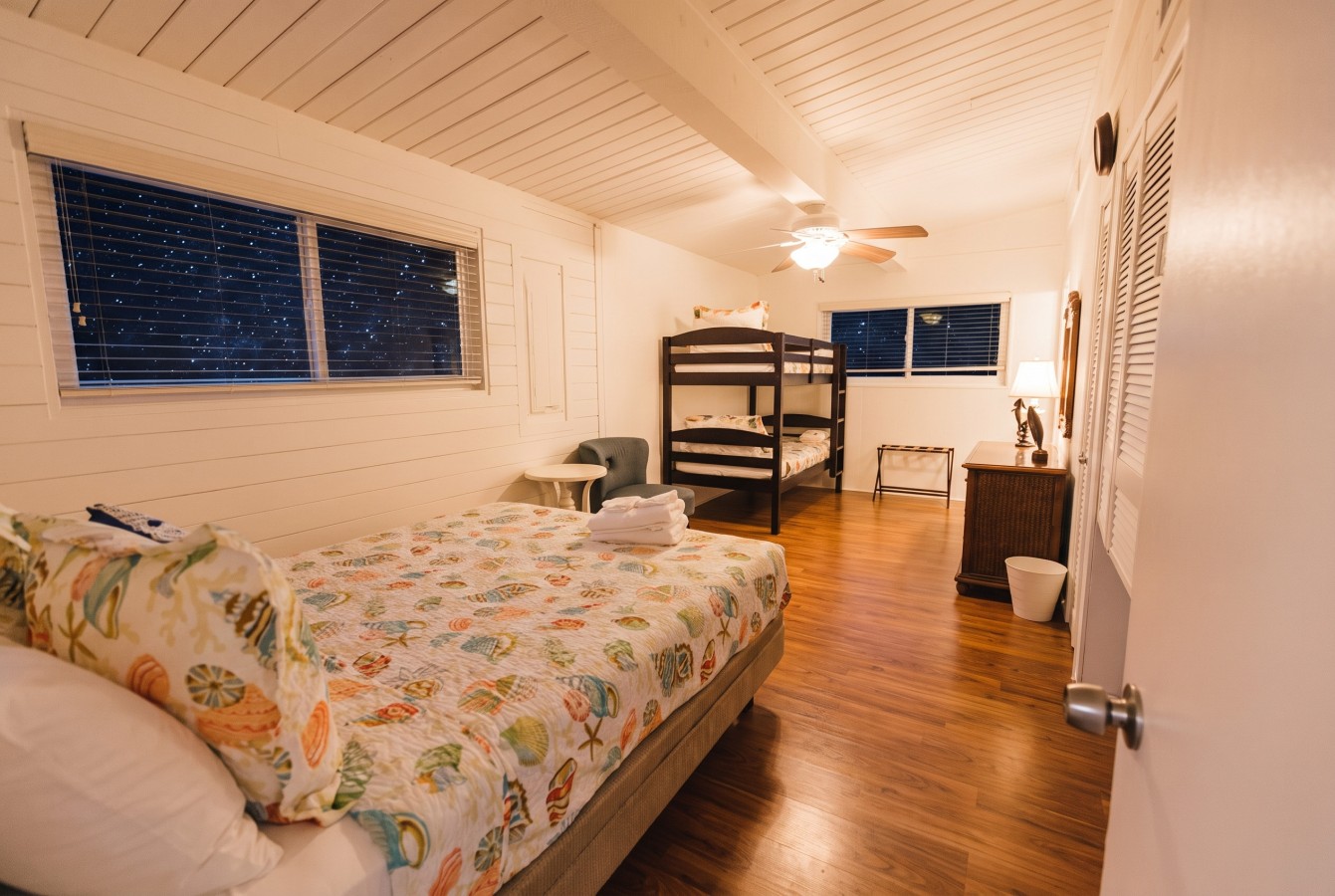 This bedroom has a queen and a twin-over-twin bunk bed