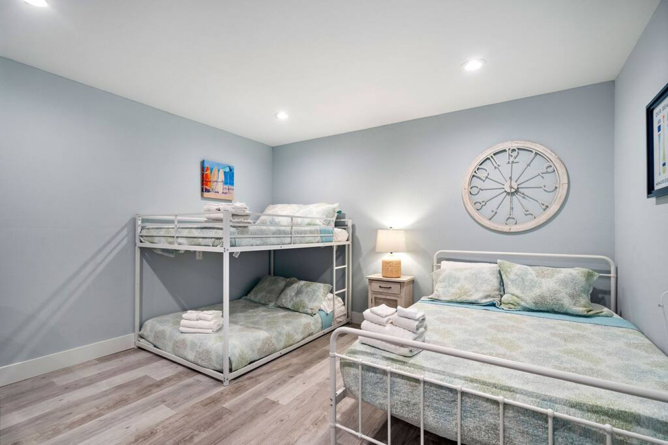This bedroom has a queen bed and a full/full bunk bed