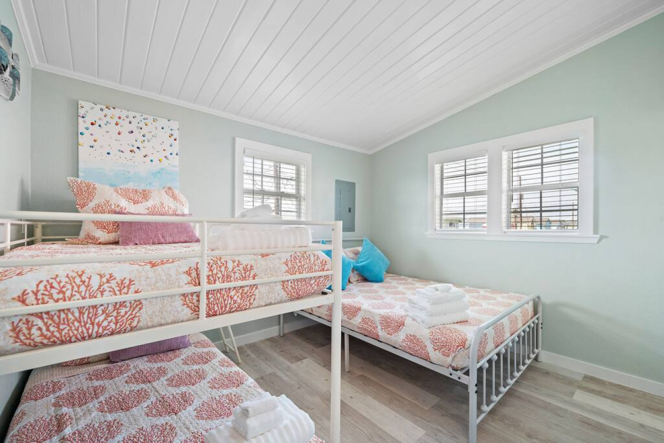 This bedroom has a queen bed and a twin/twin bunk bed