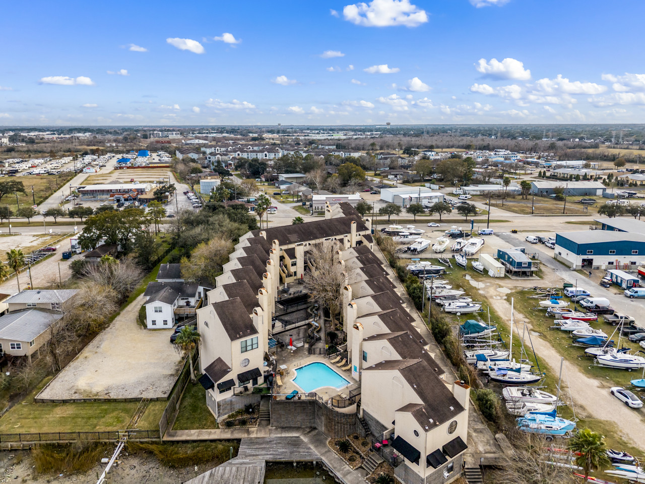 Property overview with pool and waterfront surroundings