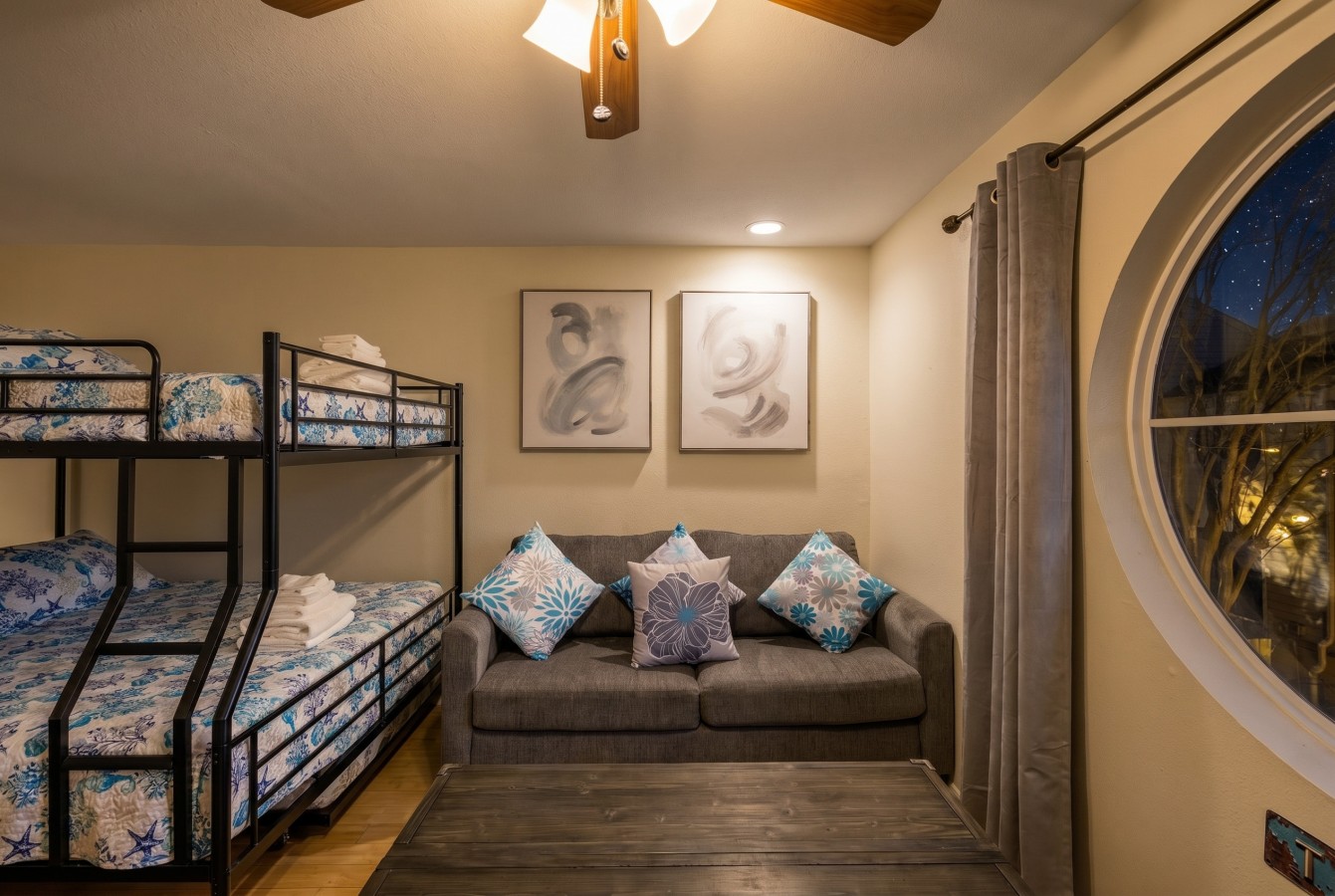 Ideal kids’ room featuring bunk beds and a comfortable couch