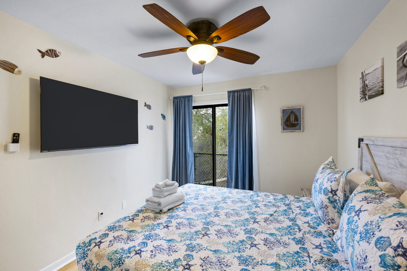 Bright coastal bedroom with queen bed & TV