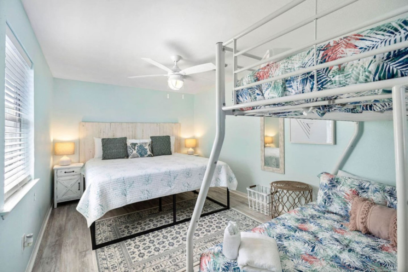 This bedroom has a queen-sized bed and full bunk beds
