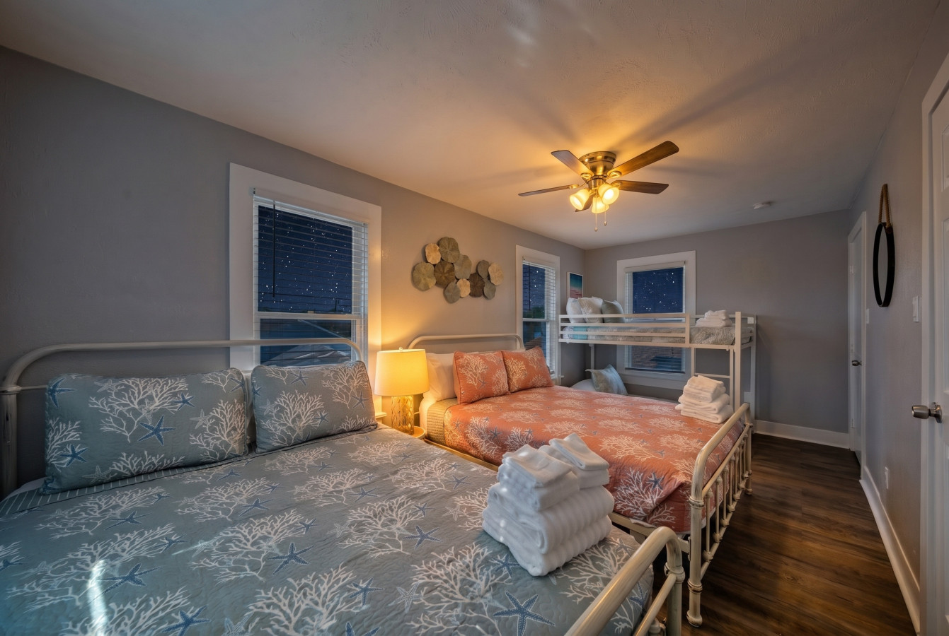 This bedroom has 2 queen beds and a twin bunk bed