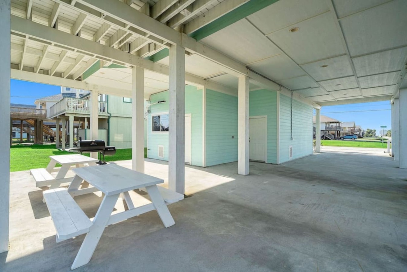 Under the home, there’s a massive, shaded barbeque area with picnic tables