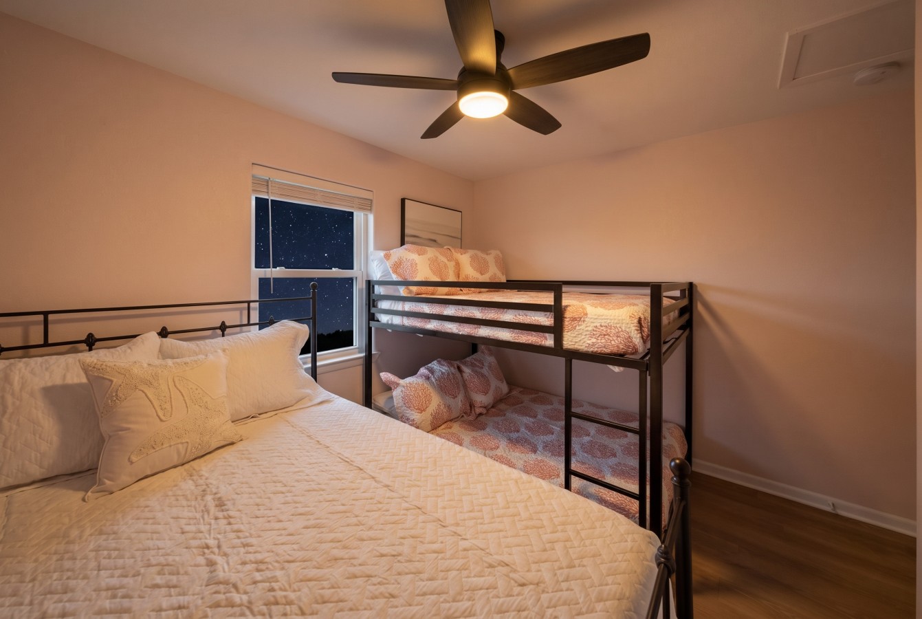 This bedroom has a queen bed and a twin-sized bunk bed