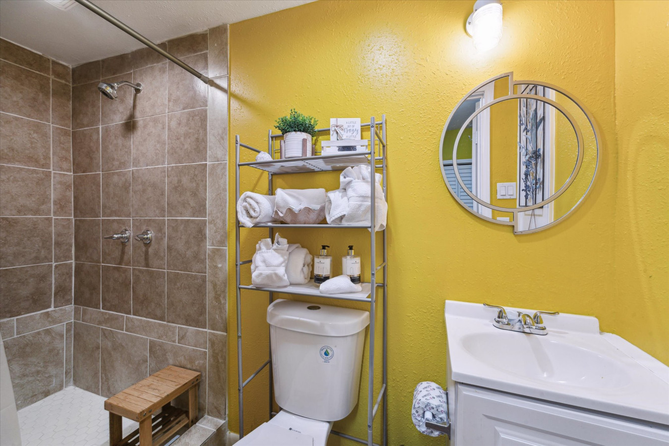 Freshen up in the spacious walk-in shower with neutral stone-style tiling
