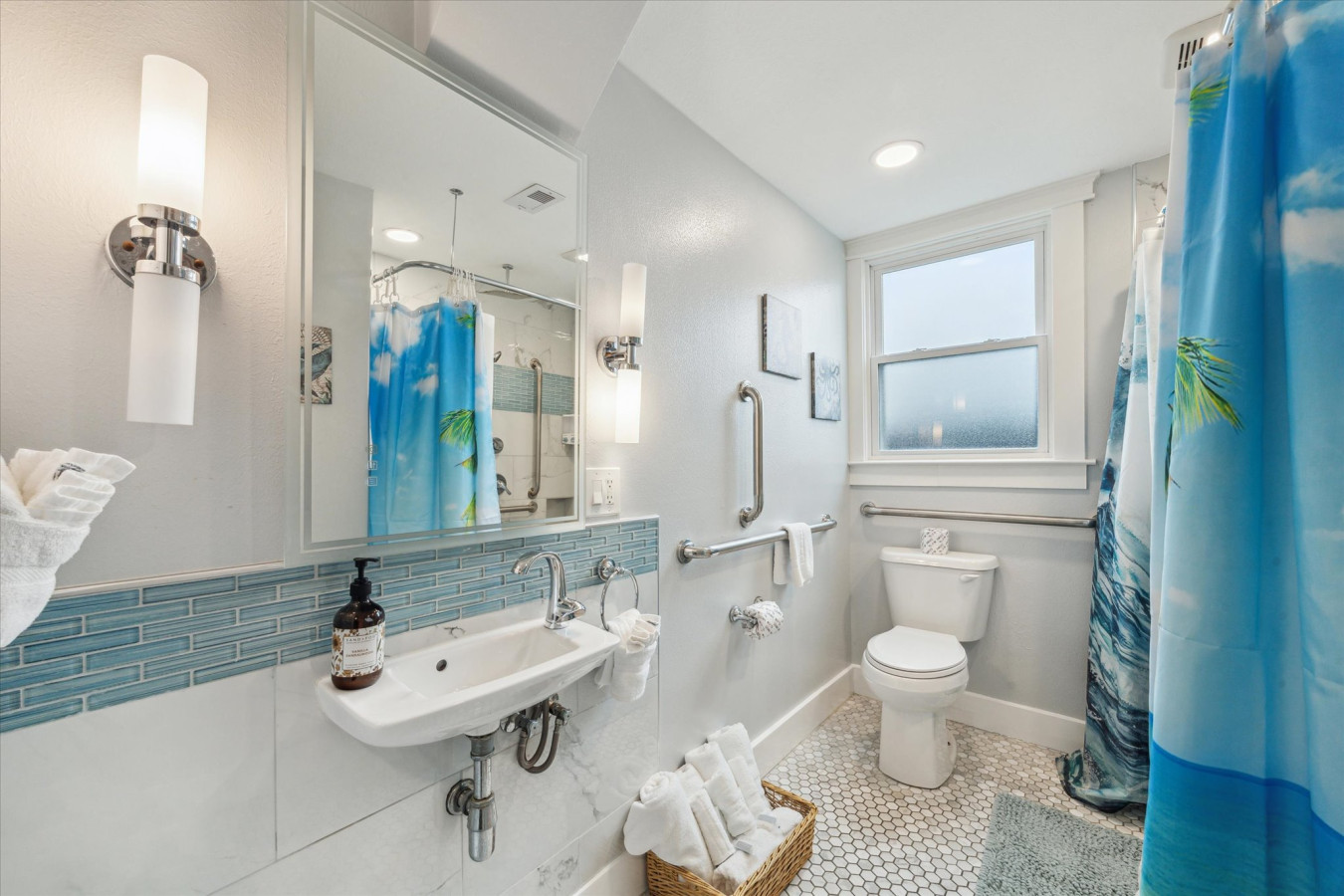 This bathroom shared by other bedrooms features a walk-in shower and modern fixtures