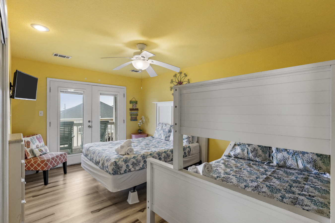 This bedroom has a queen bed and a twin/queen bunk bed