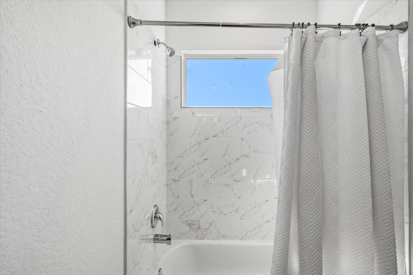 Bright bathroom with tub and shower combo